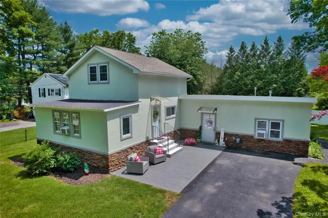 a view of backyard with a table and chairs
