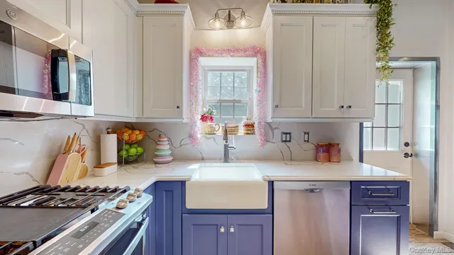 a kitchen with stainless steel appliances granite countertop a sink stove and cabinets