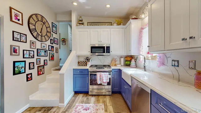 a kitchen with stainless steel appliances granite countertop a stove and a sink
