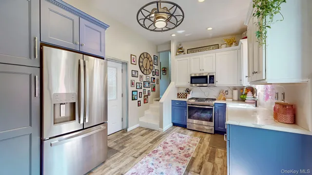 a kitchen with stainless steel appliances granite countertop a refrigerator stove and sink
