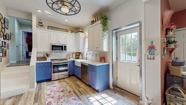 a kitchen with stainless steel appliances granite countertop a refrigerator and a sink