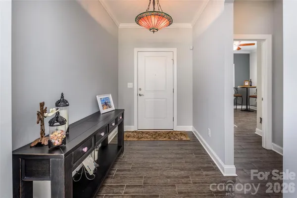 a view of a hallway to a livingroom with furniture