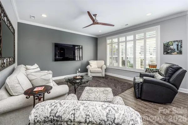 a living room with furniture wooden floor and a flat screen tv
