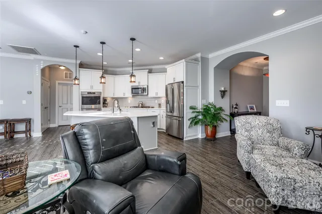 a living room with furniture and a chandelier