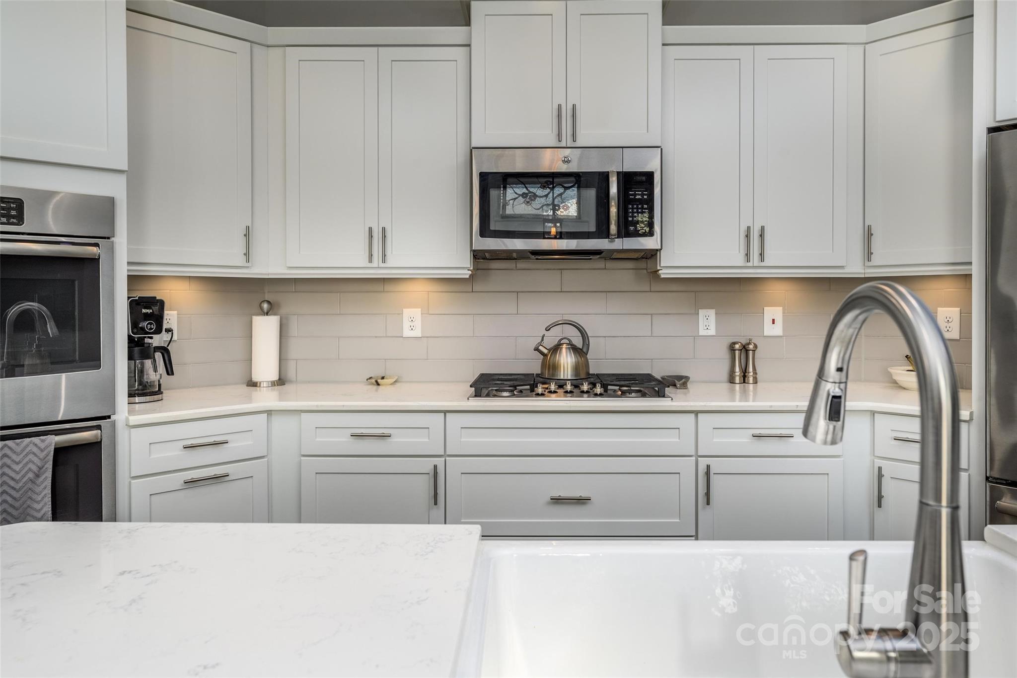 16215 Lakeside Loop Lane Cornelius, NC 28031 - Photo 17 of 48 a kitchen with white cabinets and sink