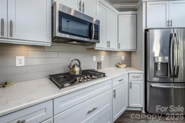 a kitchen with appliances a sink and cabinets