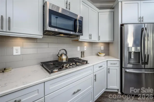 a kitchen with appliances a sink and cabinets