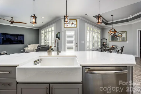 a kitchen with a table a refrigerator and a sink