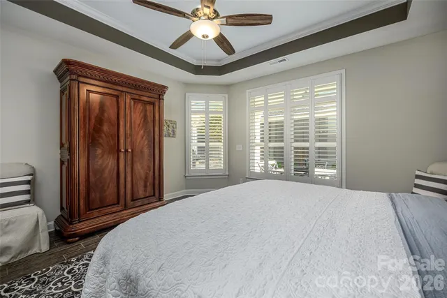 a bedroom with a large bed and a chandelier
