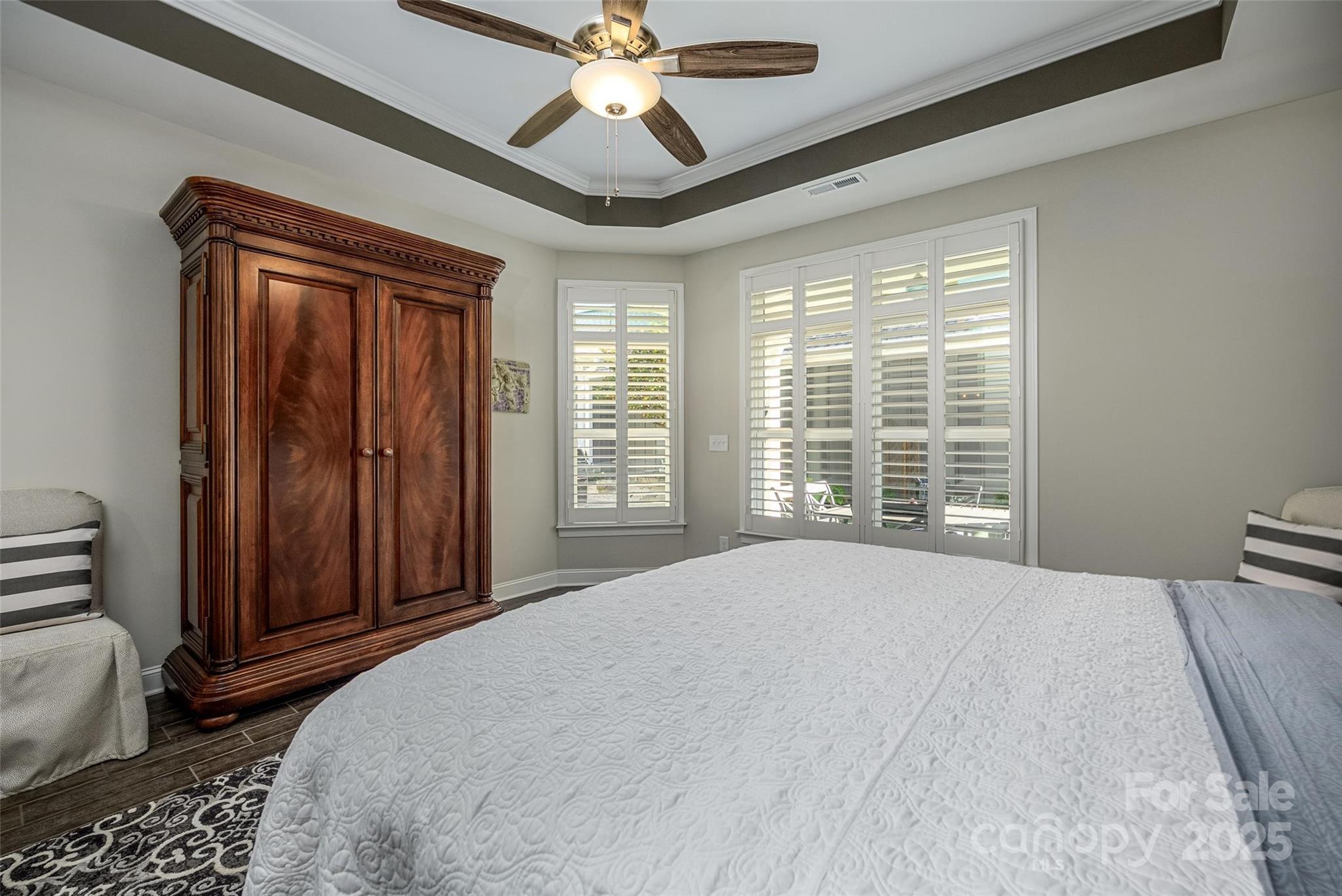 16215 Lakeside Loop Lane Cornelius, NC 28031 - Photo 29 of 48 a bedroom with a large bed and a chandelier