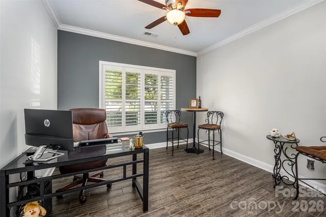 a view of a workspace with furniture and a window