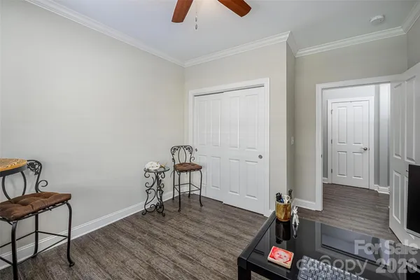a view of a room with wooden floor and furniture