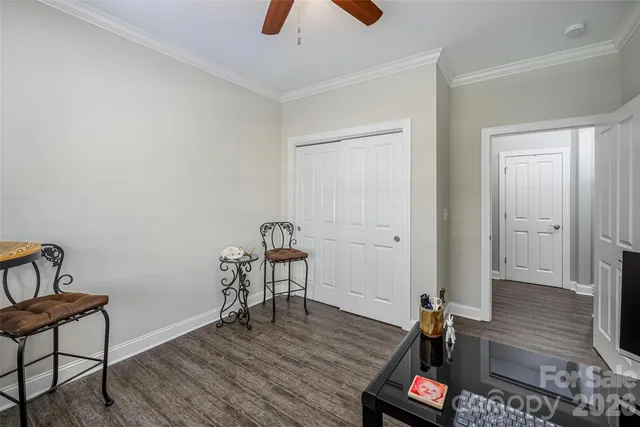 a view of a room with wooden floor and furniture