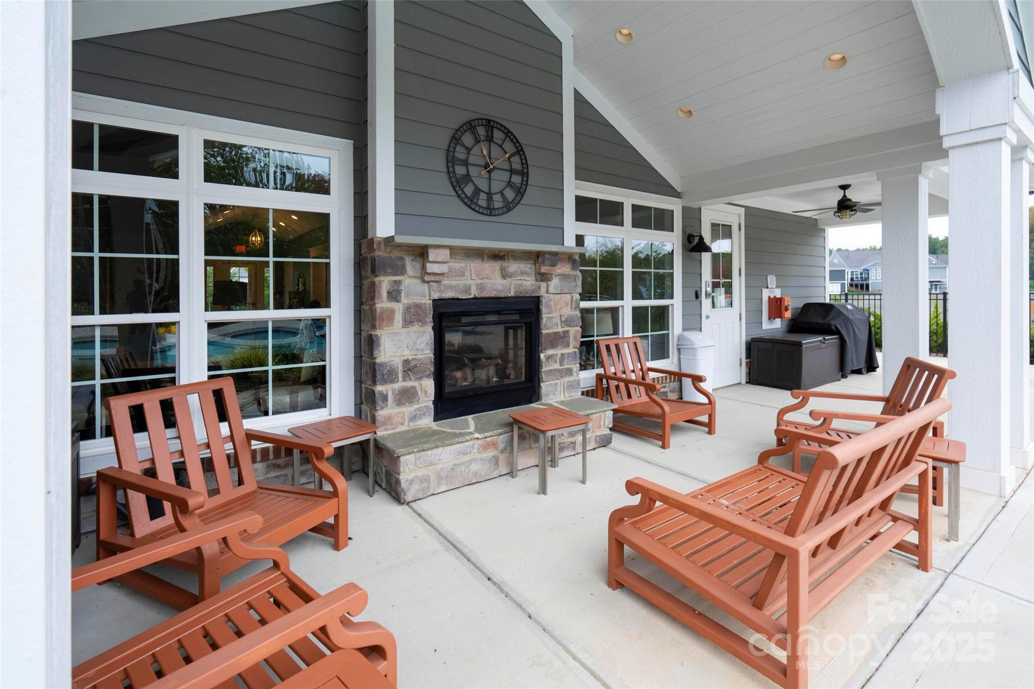 16215 Lakeside Loop Lane Cornelius, NC 28031 - Photo 45 of 48 a living room with furniture a fireplace and a large window