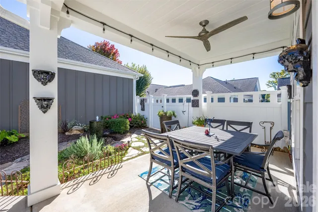 a view of a dining table and chairs in patio