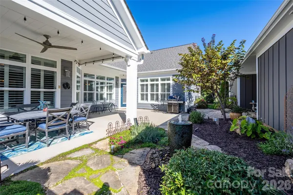 a view of a house with backyard patio and swimming pool