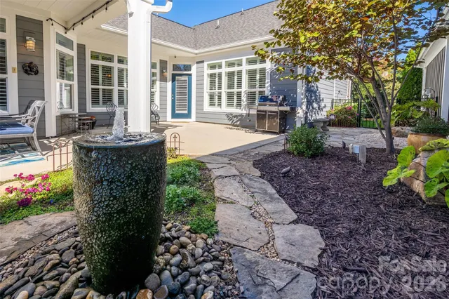a view of a house with backyard and sitting area