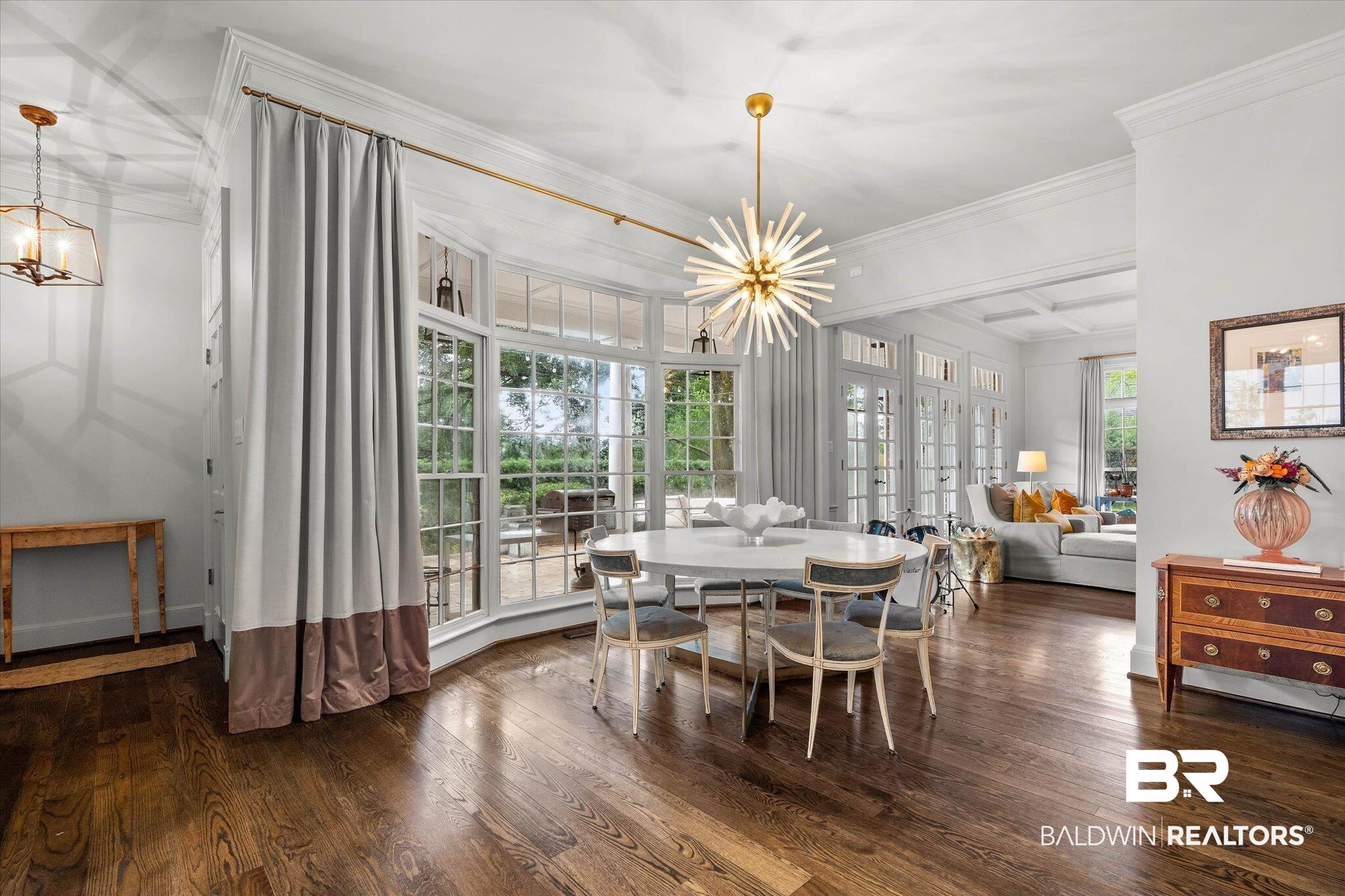 3908 Yester Place Mobile, AL 36608 - Photo 13 of 45 Spacious interior featuring wood-finish flooring and a contemporary sputnik chandelier
