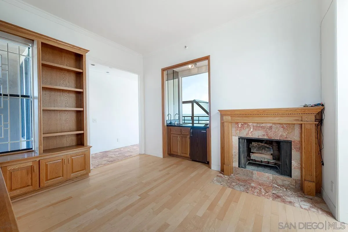 230 West Laurel Street, Unit 1001 San Diego, CA 92101 - Photo 13 of 44 a view of empty room with wooden floor and fireplace