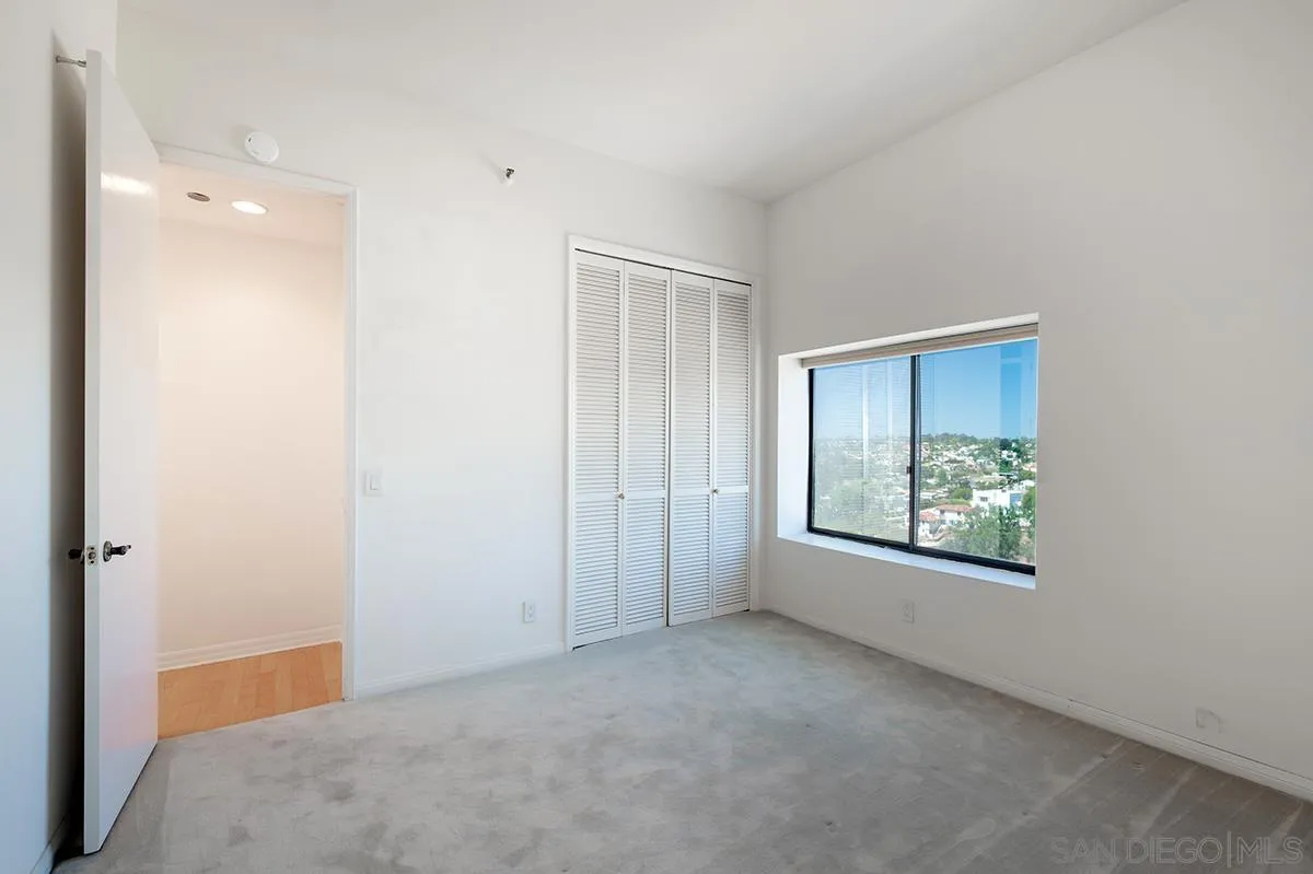 230 West Laurel Street, Unit 1001 San Diego, CA 92101 - Photo 15 of 44 an empty room with windows and closet