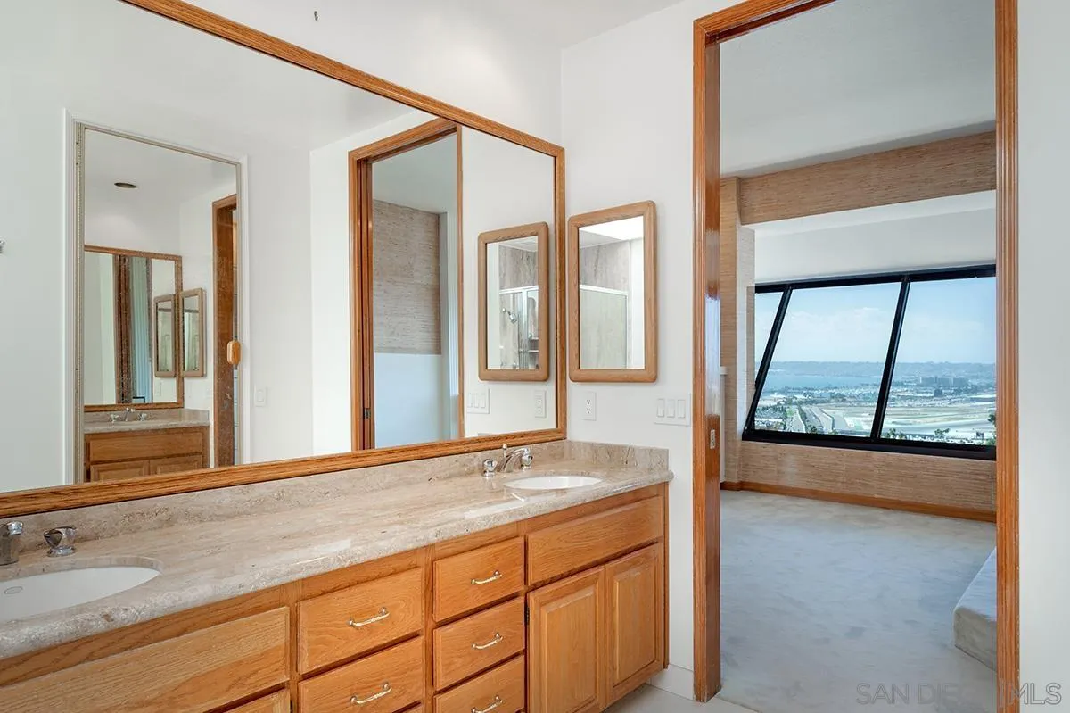 230 West Laurel Street, Unit 1001 San Diego, CA 92101 - Photo 20 of 44 a bathroom with a granite countertop sink and large window