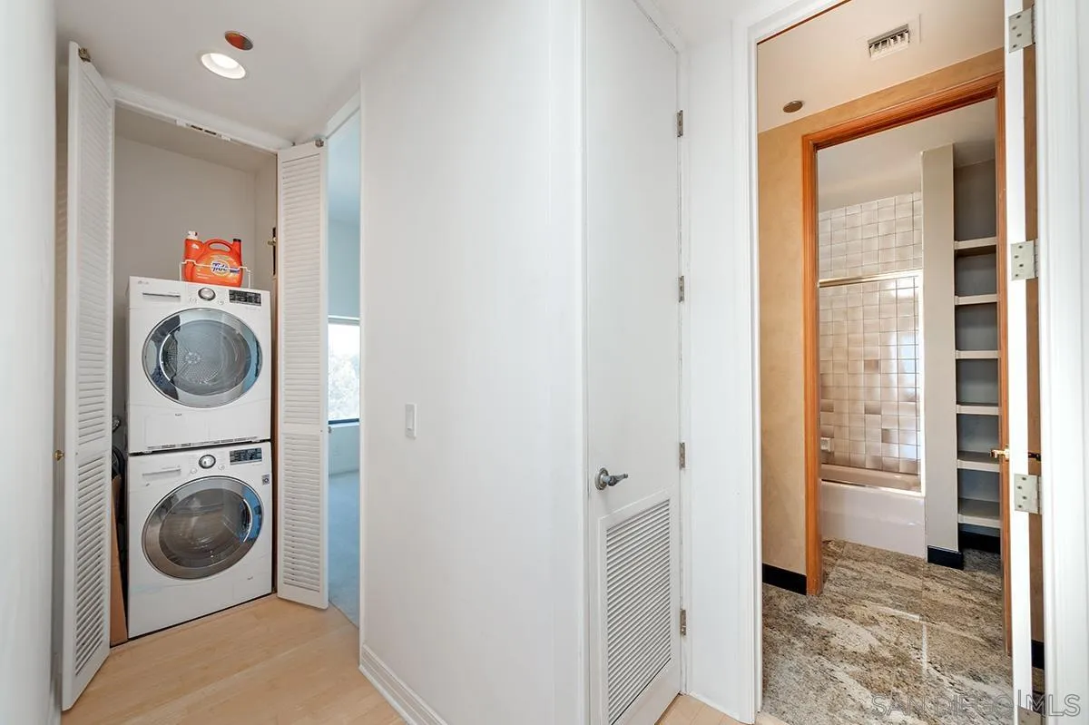 230 West Laurel Street, Unit 1001 San Diego, CA 92101 - Photo 24 of 44 a view of a hallway with washer and dryer
