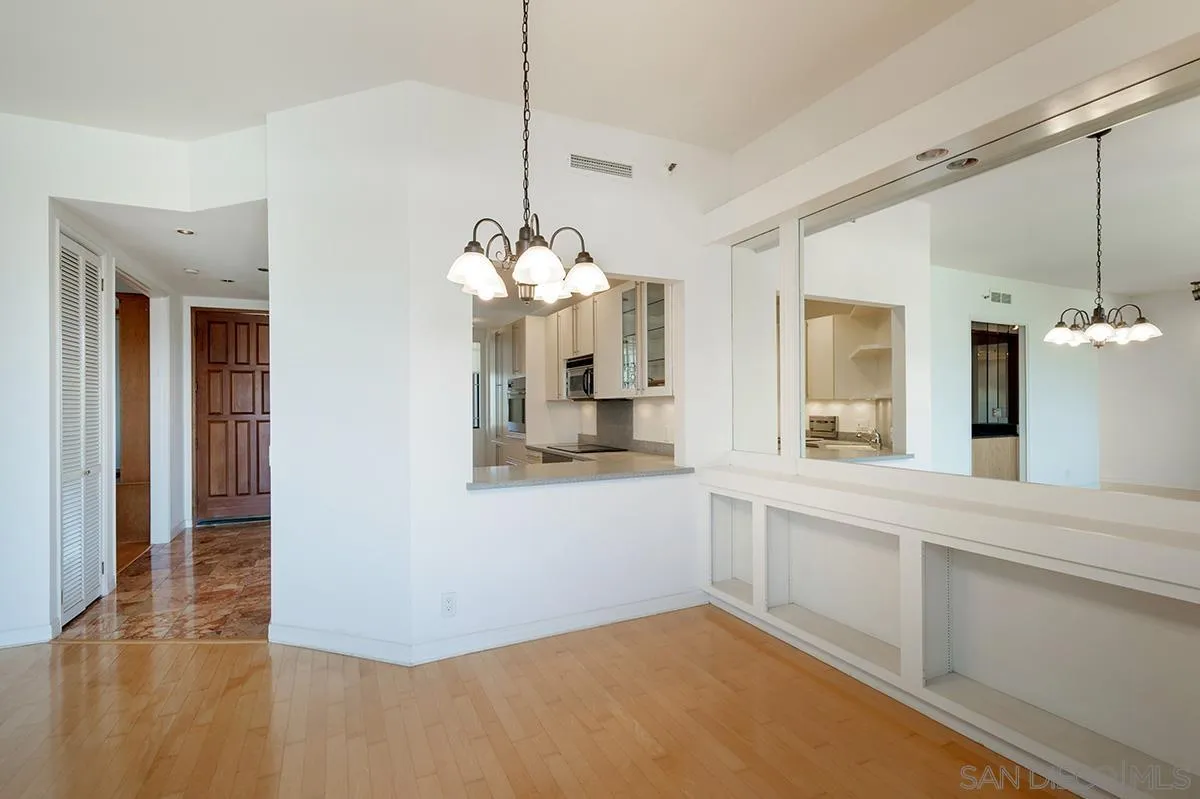 230 West Laurel Street, Unit 1001 San Diego, CA 92101 - Photo 7 of 44 a view of a kitchen with granite countertop a sink and dishwasher with wooden floor