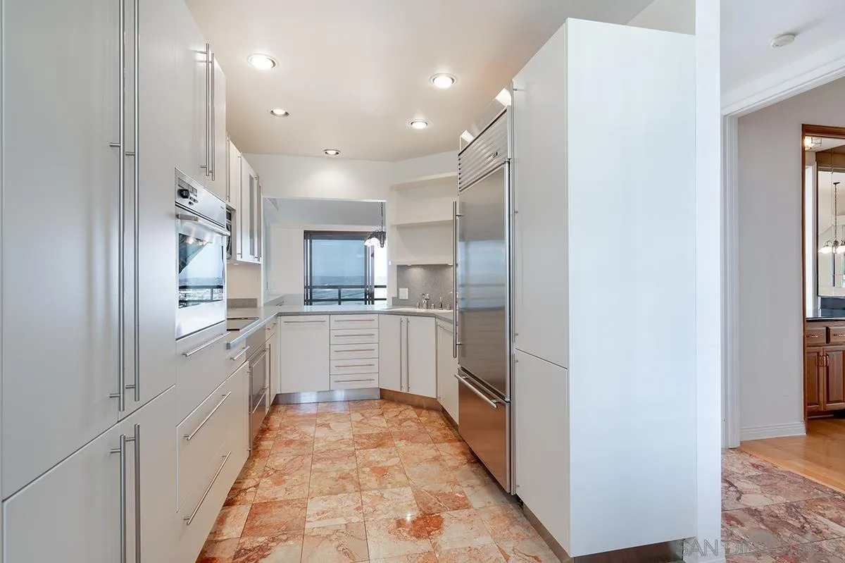 230 West Laurel Street, Unit 1001 San Diego, CA 92101 - Photo 9 of 44 a kitchen with white cabinets and white appliances