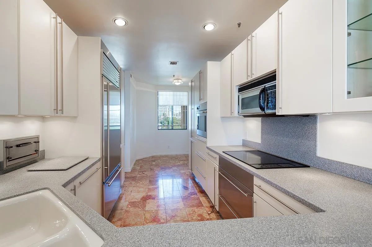 230 West Laurel Street, Unit 1001 San Diego, CA 92101 - Photo 10 of 44 a kitchen with stainless steel appliances granite countertop a sink a stove a microwave a refrigerator a cabinets and wooden floor