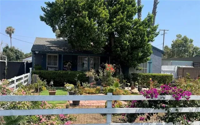 a front view of a house with a yard and fountain
