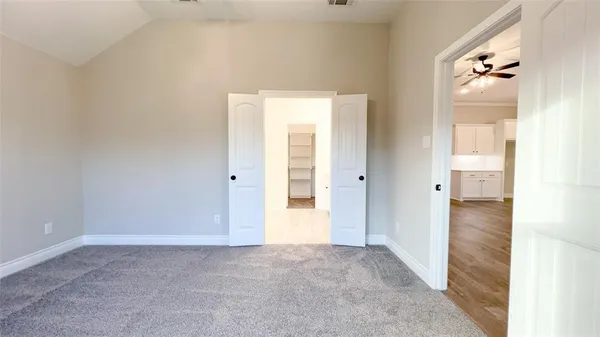 an empty room with fan and entrance
