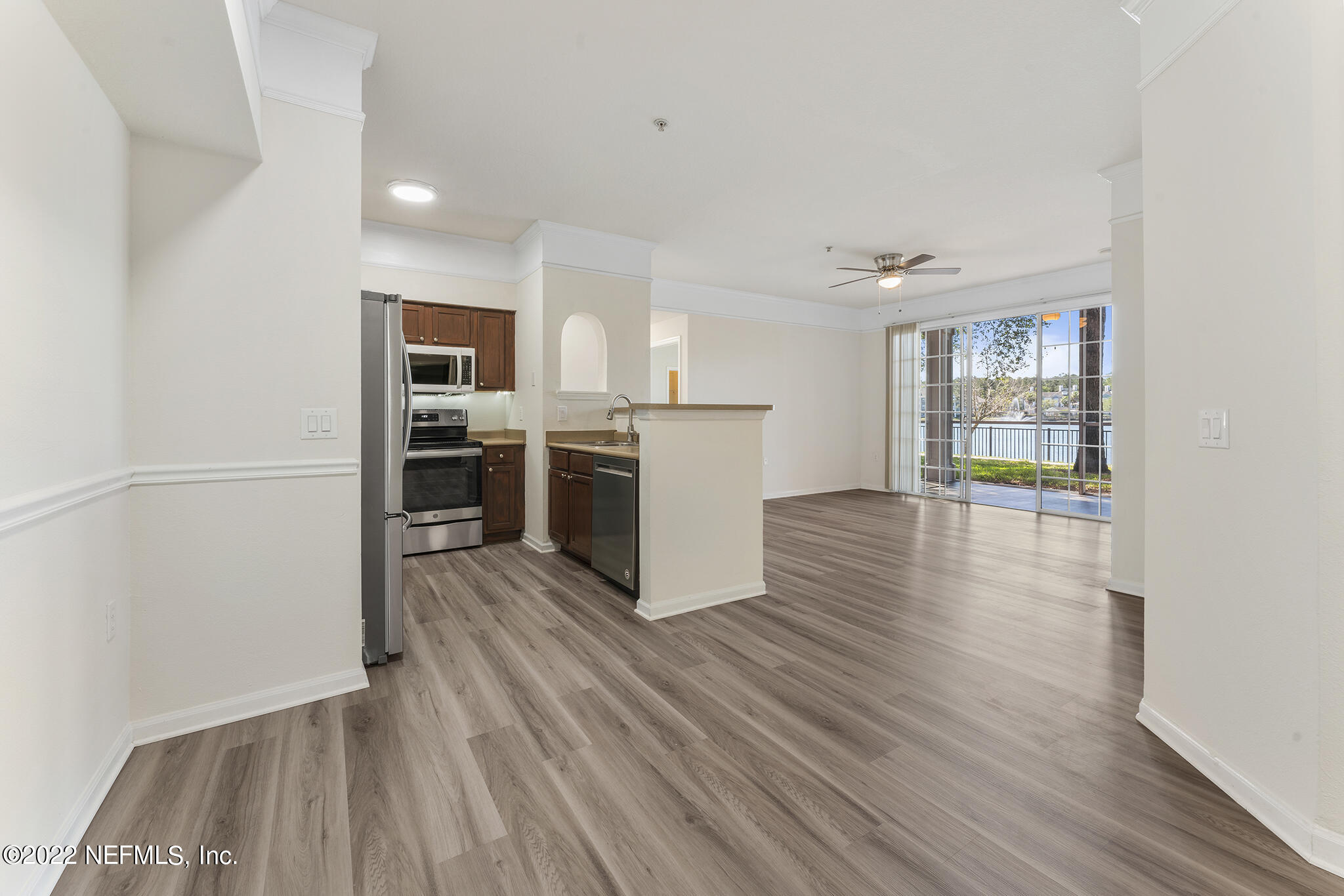 8550 Touchton Road, Unit 812 Jacksonville, FL 32216 - Photo 9 of 44 a kitchen with wooden floors and stainless steel appliances