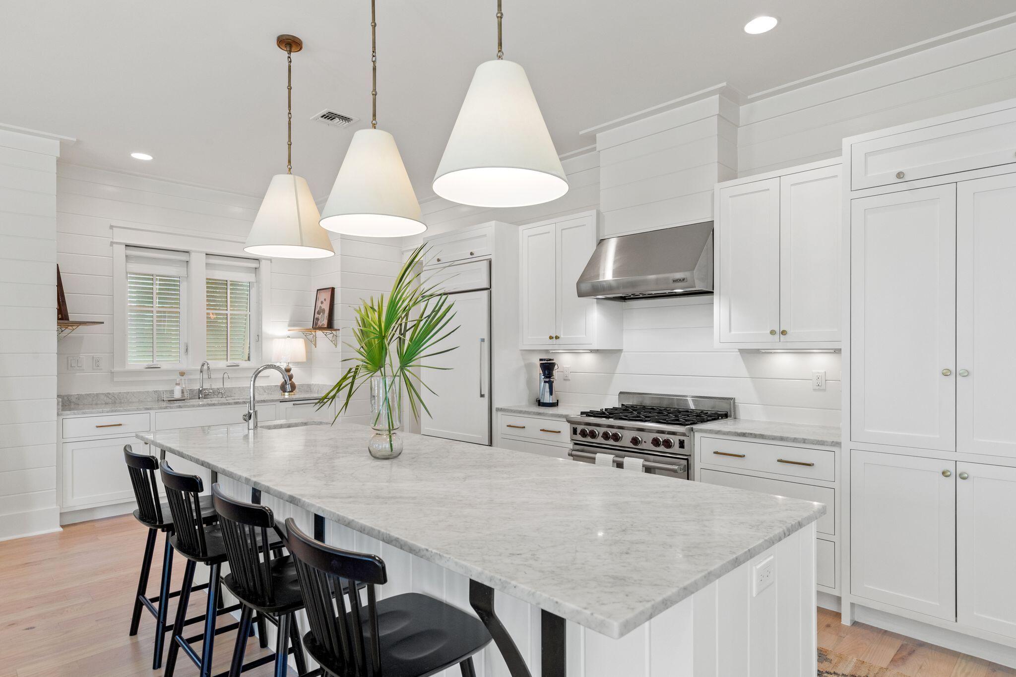 97 Sunflower Street Santa Rosa Beach, FL 32459 - Photo 16 of 86 a kitchen with stainless steel appliances granite countertop a kitchen island a stove a table and chairs