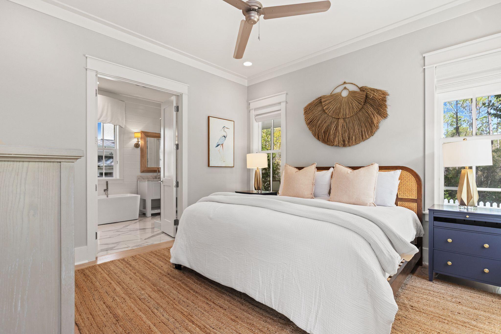 97 Sunflower Street Santa Rosa Beach, FL 32459 - Photo 24 of 86 a bedroom with a bed and a chandelier