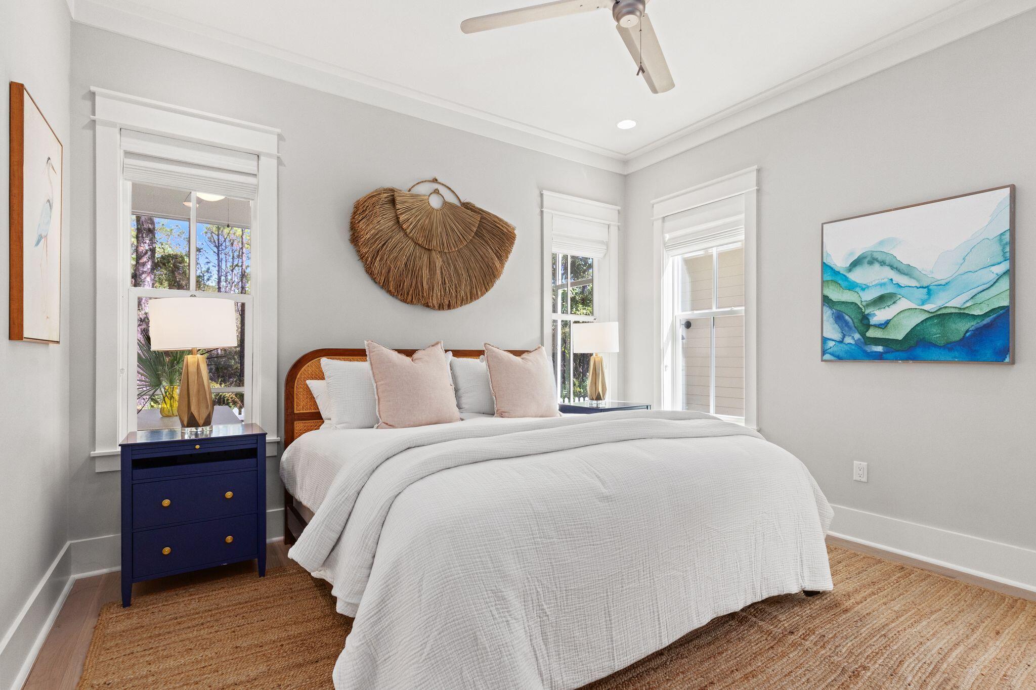 97 Sunflower Street Santa Rosa Beach, FL 32459 - Photo 25 of 86 a bedroom with a bed and a painting on the wall