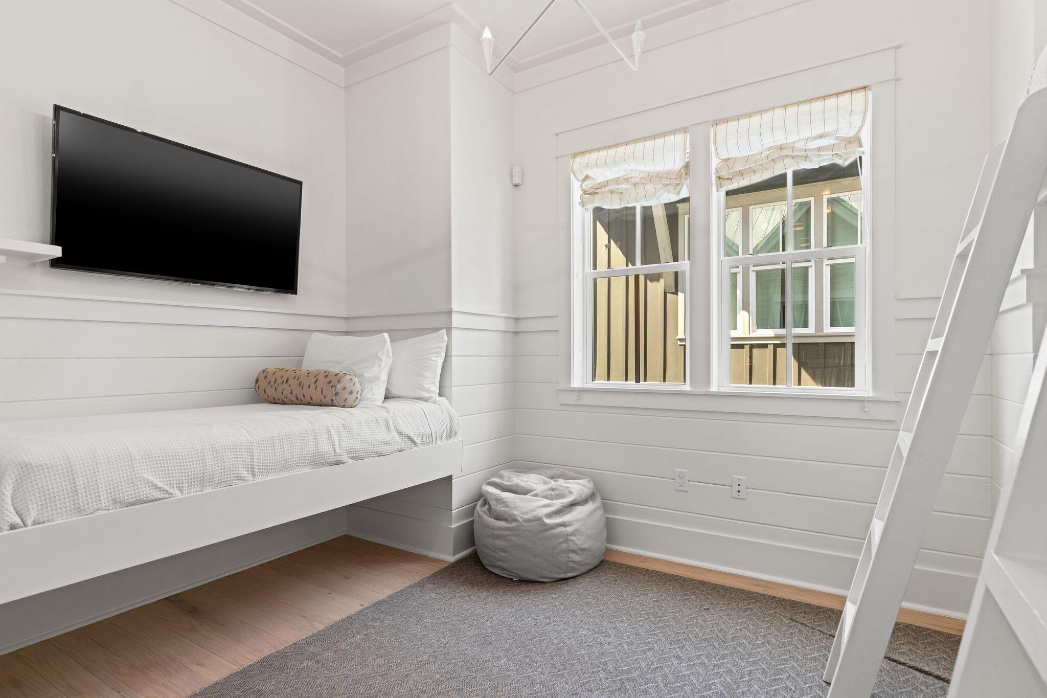 97 Sunflower Street Santa Rosa Beach, FL 32459 - Photo 34 of 86 a spacious bedroom with a bed and a flat screen tv