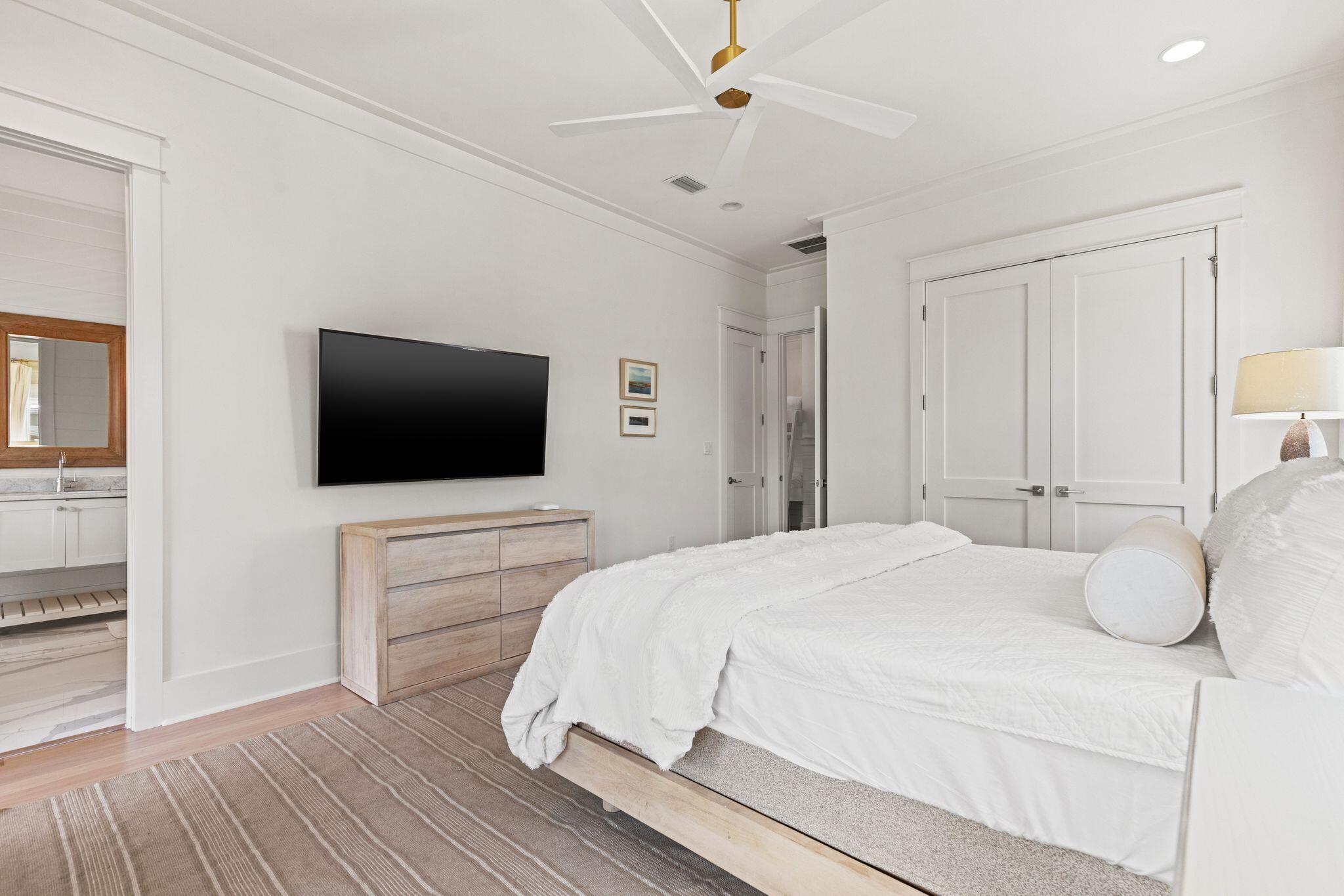 97 Sunflower Street Santa Rosa Beach, FL 32459 - Photo 38 of 86 a bedroom with a bed and a flat screen tv