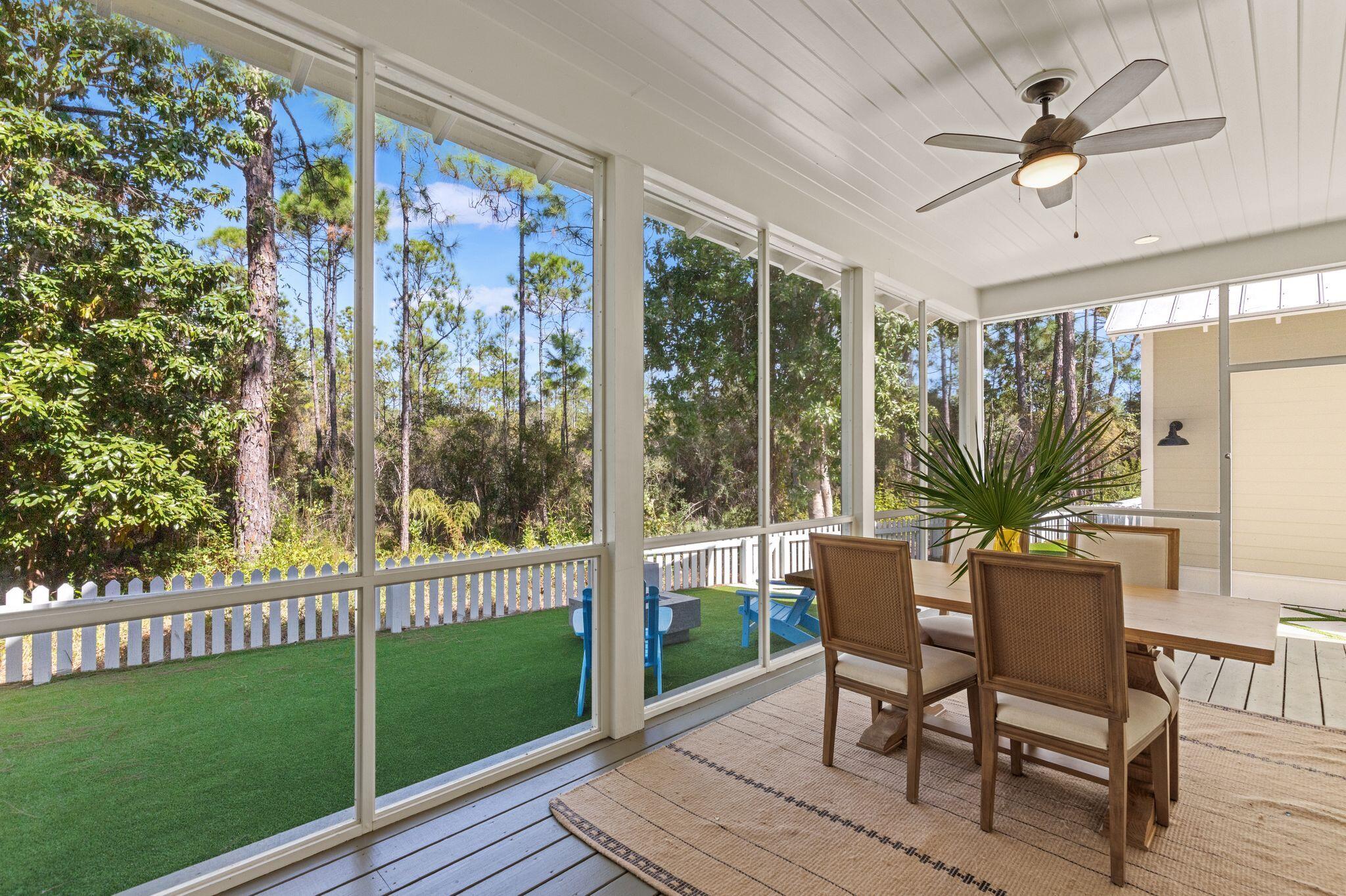 97 Sunflower Street Santa Rosa Beach, FL 32459 - Photo 56 of 86 a view of a porch with furniture and a yard