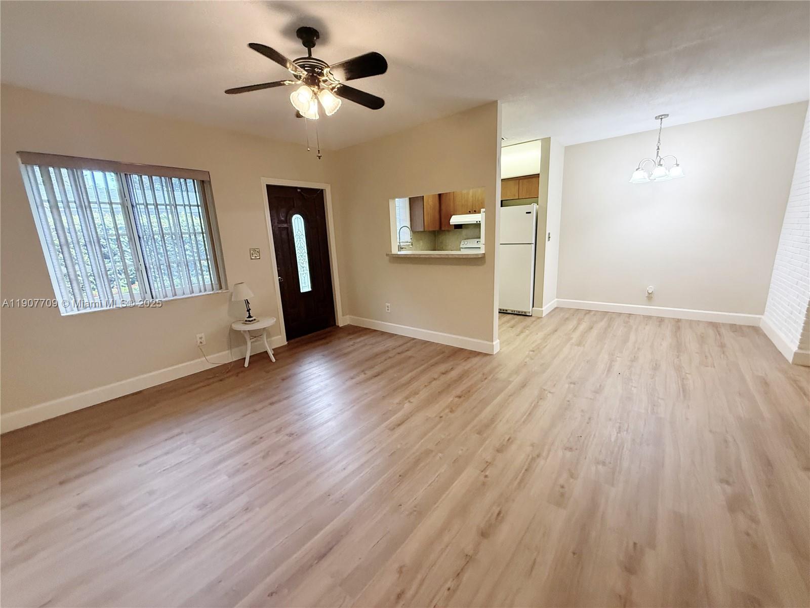 216 Southwest 10th Street, Unit 2 Hallandale Beach, FL 33009 - Photo 1 of 14 wooden floor in an empty room with a window