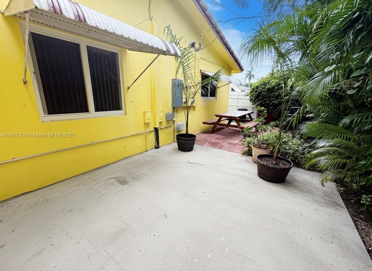 216 Southwest 10th Street, Unit 2 Hallandale Beach, FL 33009 - Photo 13 of 14 a view of a path along with potted plants