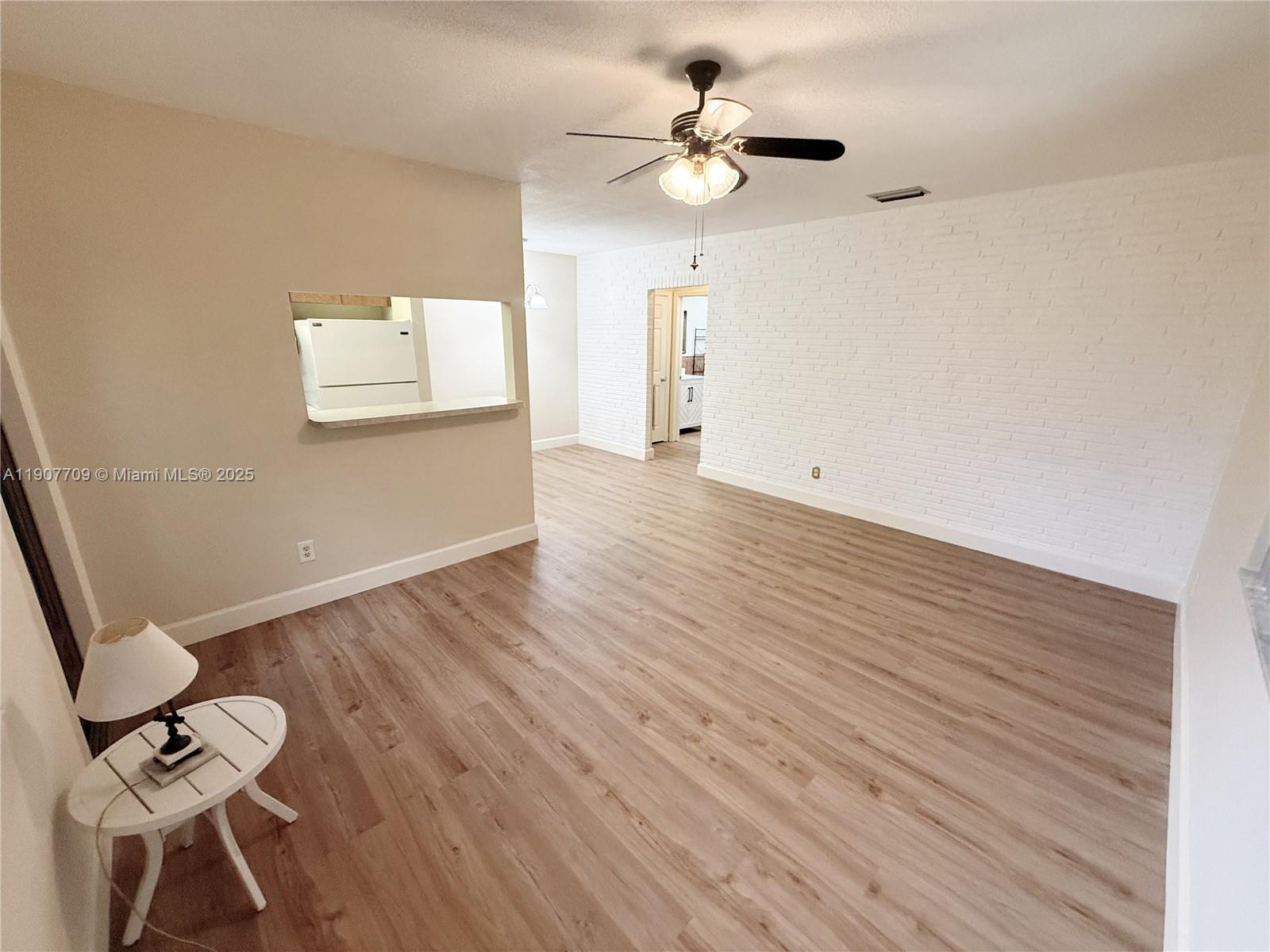 216 Southwest 10th Street, Unit 2 Hallandale Beach, FL 33009 - Photo 2 of 14 a view of an empty room with a window