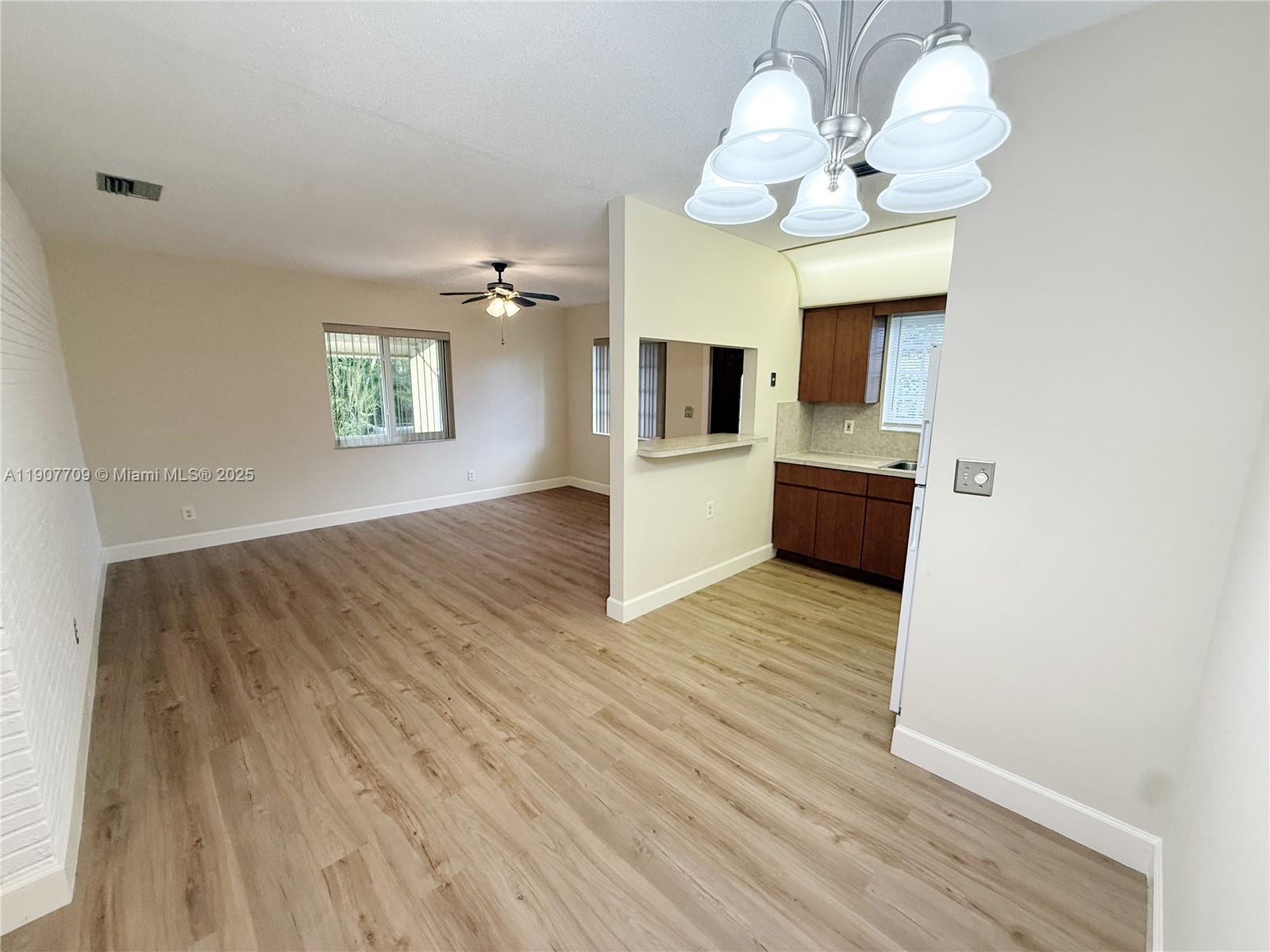 216 Southwest 10th Street, Unit 2 Hallandale Beach, FL 33009 - Photo 3 of 14 a view of kitchen with furniture and wooden floor