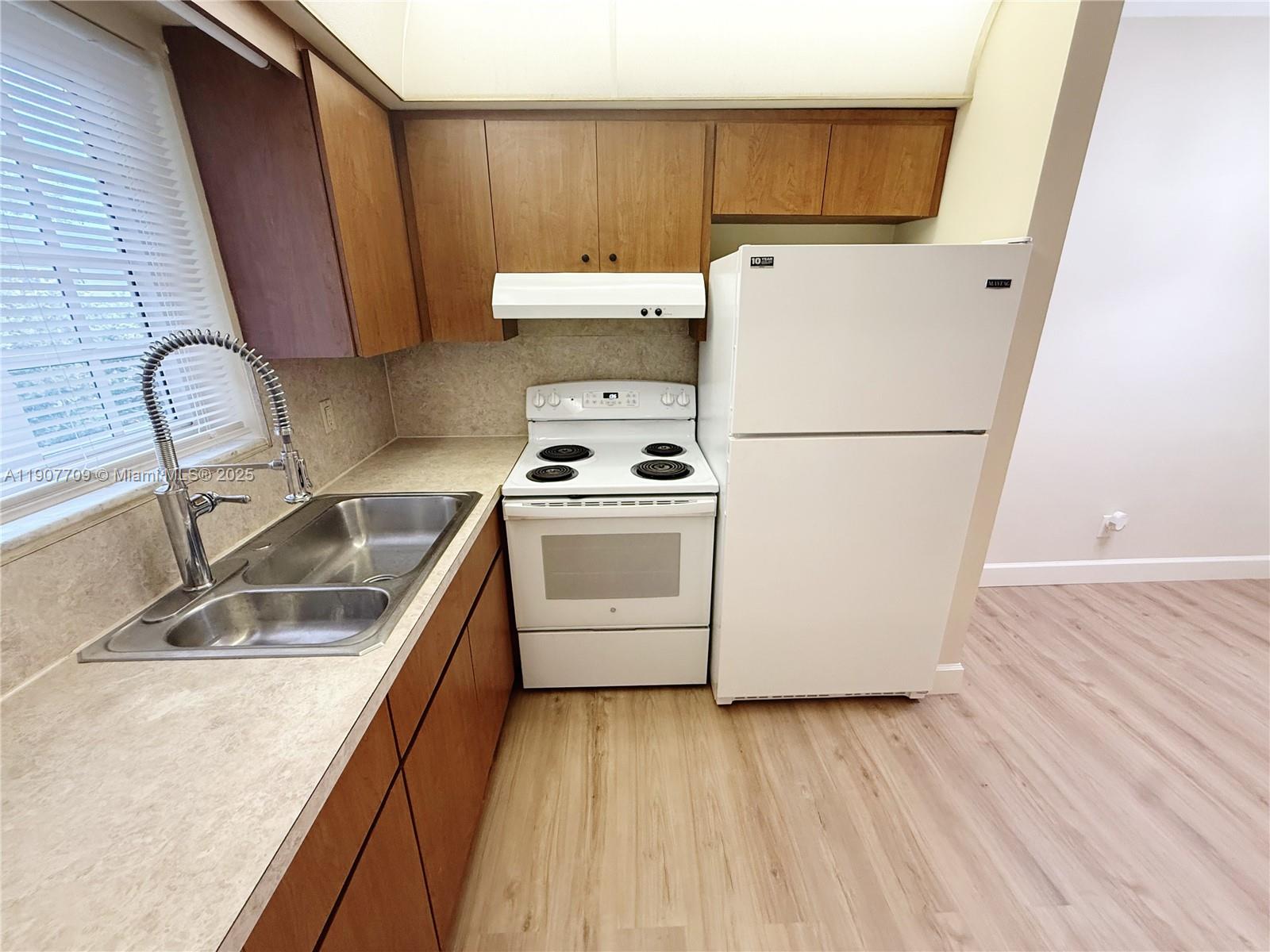 216 Southwest 10th Street, Unit 2 Hallandale Beach, FL 33009 - Photo 5 of 14 a utility room with dryer and washer
