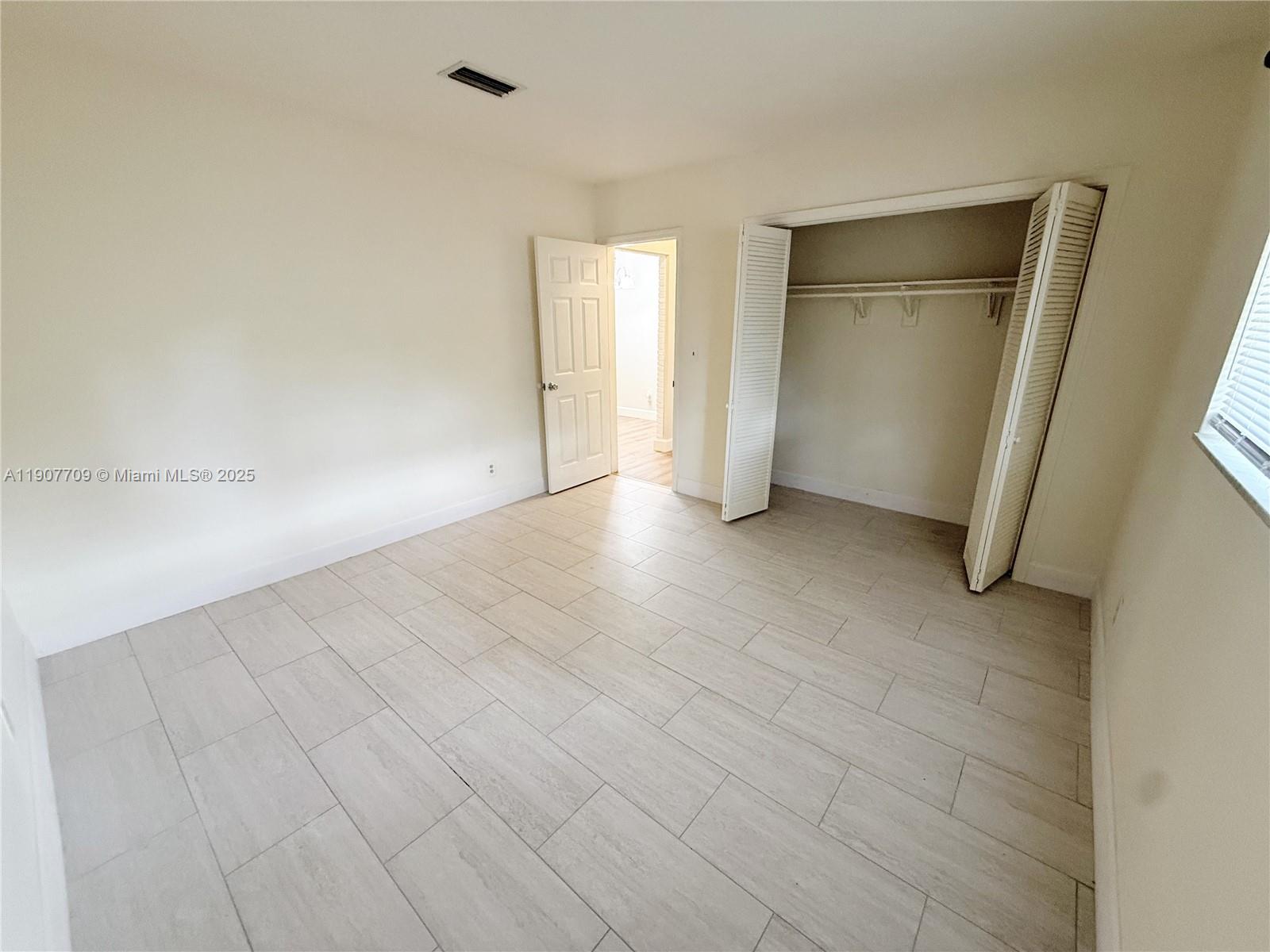 216 Southwest 10th Street, Unit 2 Hallandale Beach, FL 33009 - Photo 6 of 14 a view of an empty room and closet area