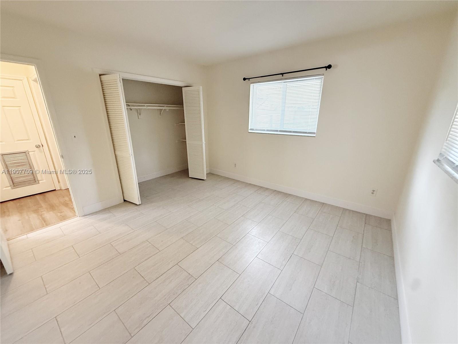 216 Southwest 10th Street, Unit 2 Hallandale Beach, FL 33009 - Photo 7 of 14 an empty room with windows