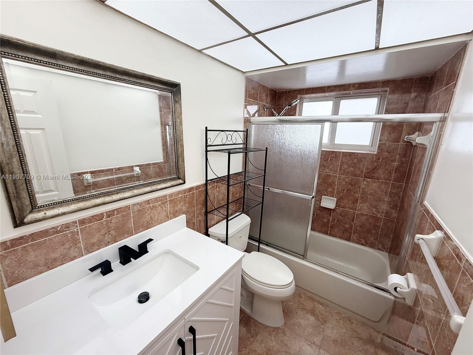 216 Southwest 10th Street, Unit 2 Hallandale Beach, FL 33009 - Photo 9 of 14 a bathroom with a sink a toilet and shower