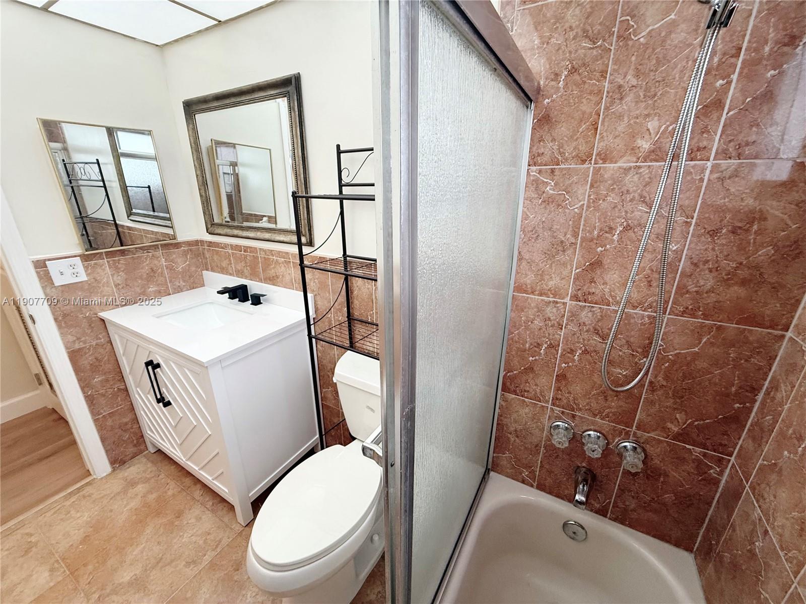 216 Southwest 10th Street, Unit 2 Hallandale Beach, FL 33009 - Photo 10 of 14 a white toilet sitting next to a bathroom sink