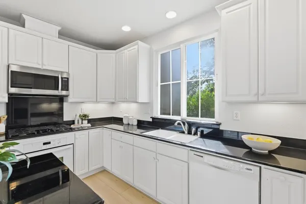 a kitchen with a sink stove and microwave