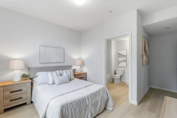 a bedroom with a bed and a lamp