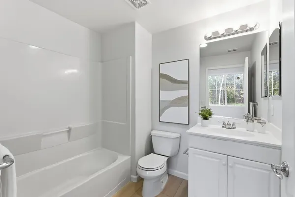 a bathroom with a sink toilet tub and shower